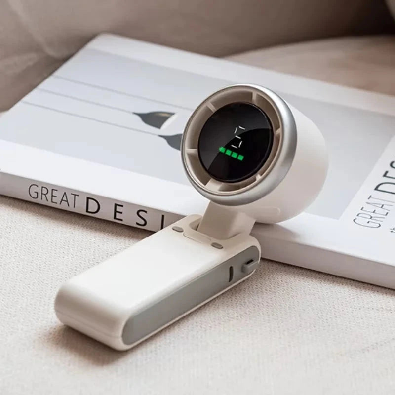 White portable fan with digital display on a book
